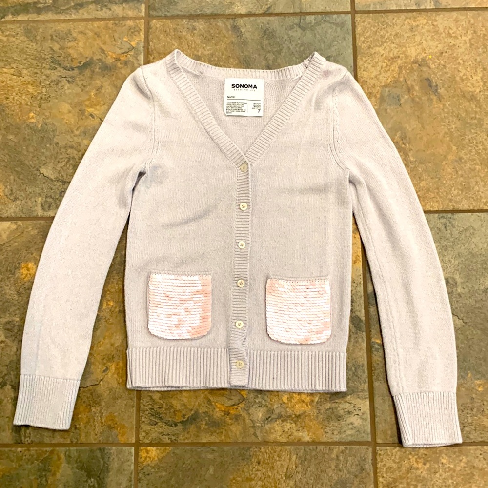 Girls Sonoma sweater with pink sequins on the pockets.